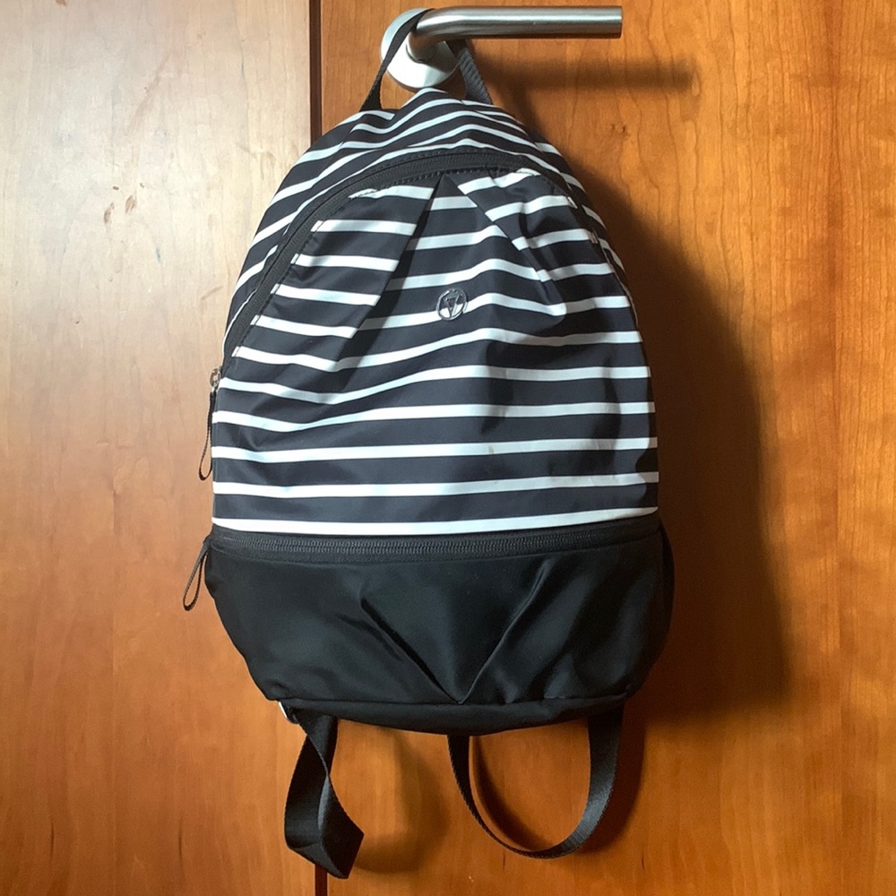 This is a black and white stripped mini backpack from Ivivva.